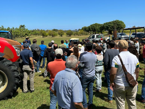 a group of farmers attend an outdoor educational workshop