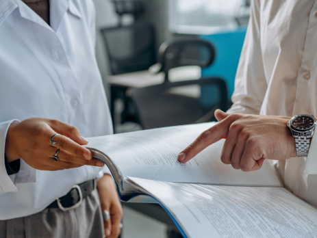 two people look at a financial document