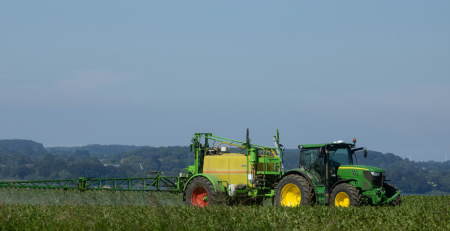 a tractor spraying pesticides