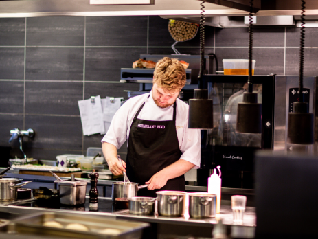 man cooking in an industrial kitchen