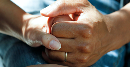closeup photo of two people holding hands