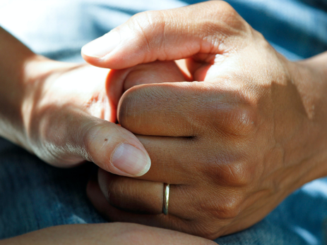 closeup photo of two people holding hands