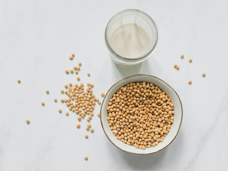 a cup of soy milk and bowl of soybeans