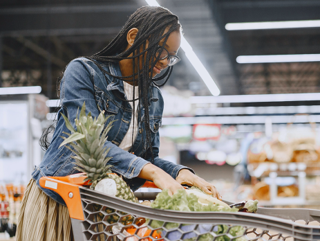 a woman checks her shopping cart at the grocery store