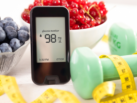 Photo of blueberries, glucose monitor, cherries, dumbbell and tape measure