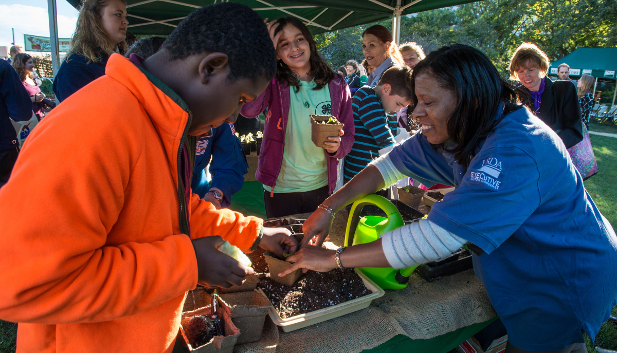 4-H fair, agent samples planting for a group of students