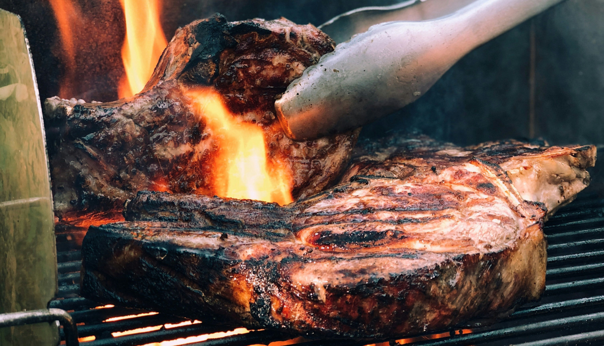 grilling steaks on the grill