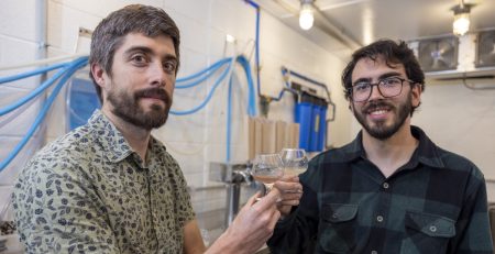 Scott Lafontaine stands with Bernardo Guimaraes in their small-scale beverage development facility