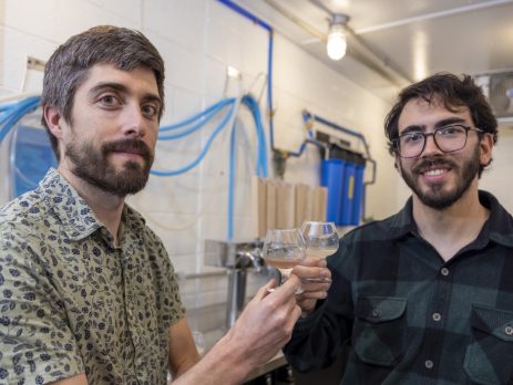 Scott Lafontaine stands with Bernardo Guimaraes in their small-scale beverage development facility