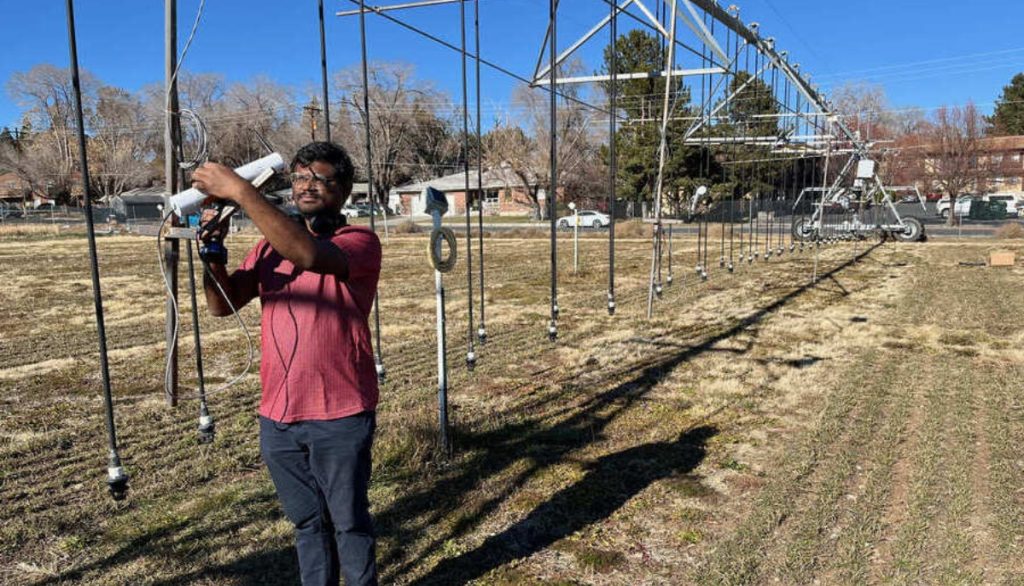 a researcher examines equipment for irrigation measurement