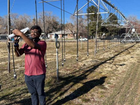 a researcher examines equipment for irrigation measurement