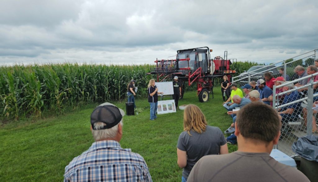 farmers watch a demonstration at a field day