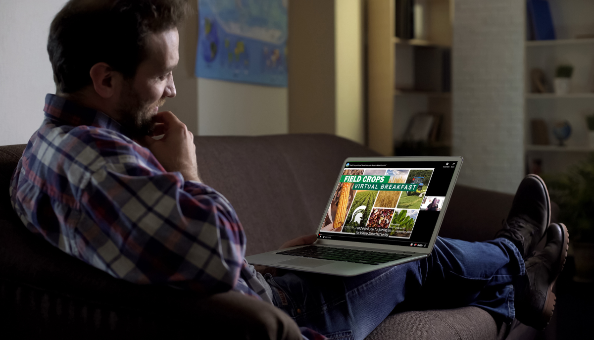 a person watching the "Field Crops Virtual Breakfast" on a laptop