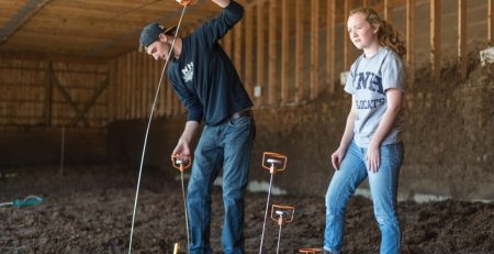 two students test manure at UNH Organic Research Dairy Farm