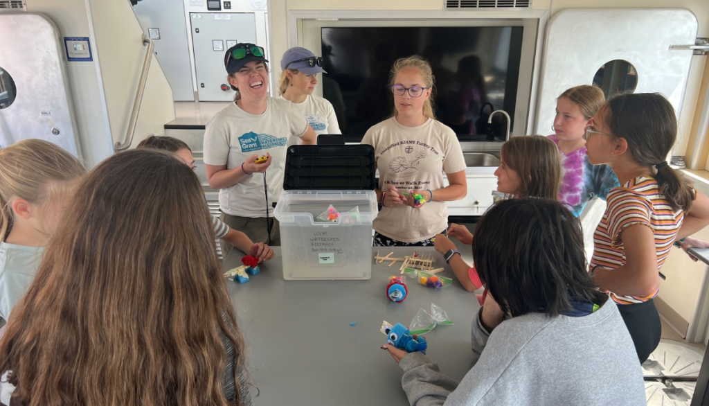 a group of students an instructor work on a project together