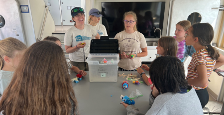 a group of students an instructor work on a project together