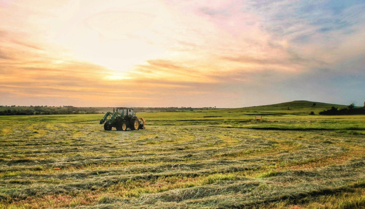 tractor driving through a field
