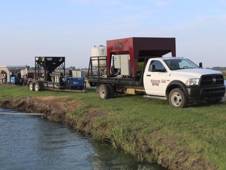 Scientists test a vaccine and delivery system at a catfish pond.
