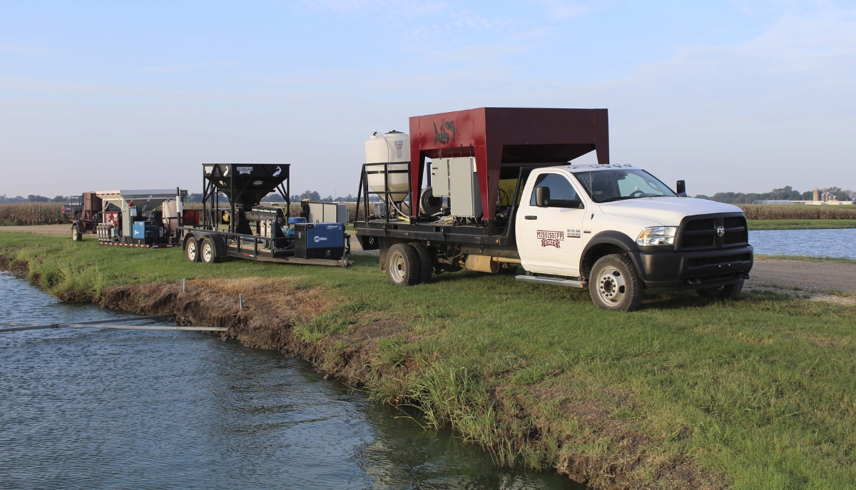 Scientists test a vaccine and delivery system at a catfish pond.