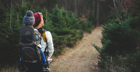 person hiking wearing a baby carrier