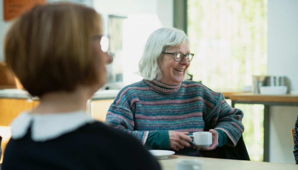 two seniors drinking tea at a table