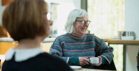 two seniors drinking tea at a table