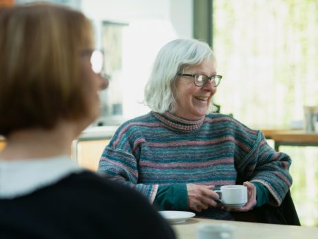 two seniors drinking tea at a table