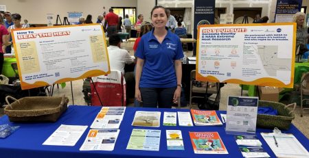 Extension agent at a table plans to talk to people about how Sarasota County is helping mitigate the urban heat island effect.