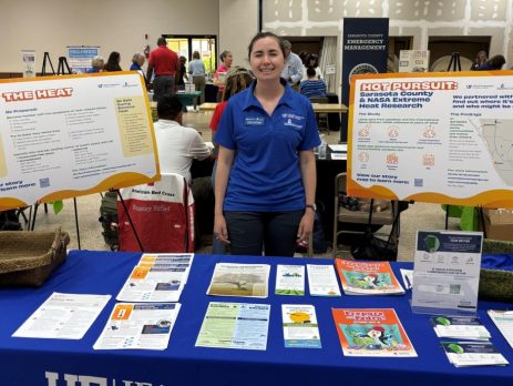 Extension agent at a table plans to talk to people about how Sarasota County is helping mitigate the urban heat island effect.