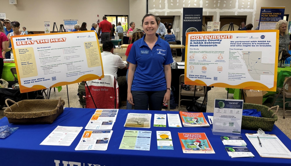 Extension agent at a table plans to talk to people about how Sarasota County is helping mitigate the urban heat island effect.