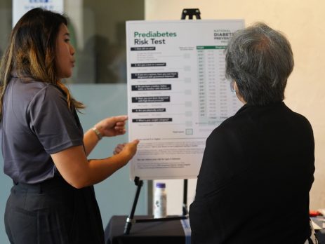 an Extension educator talks toa community member about a prediabetes risk test