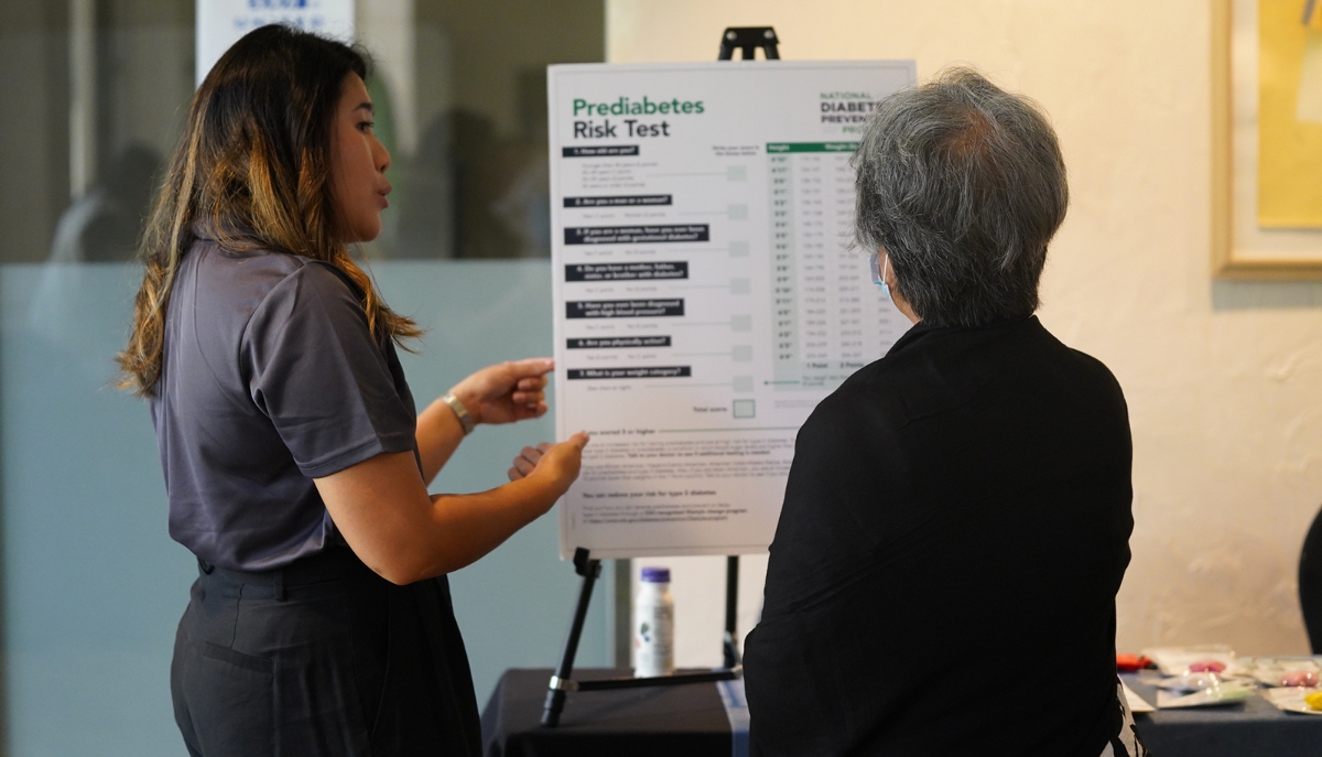 an Extension educator talks toa community member about a prediabetes risk test