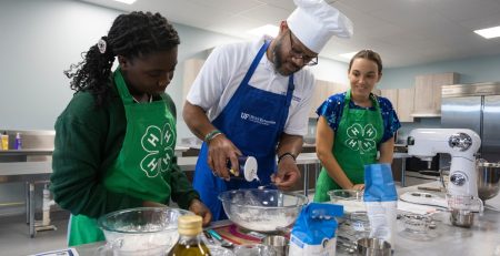 4-H teens and instructor baking