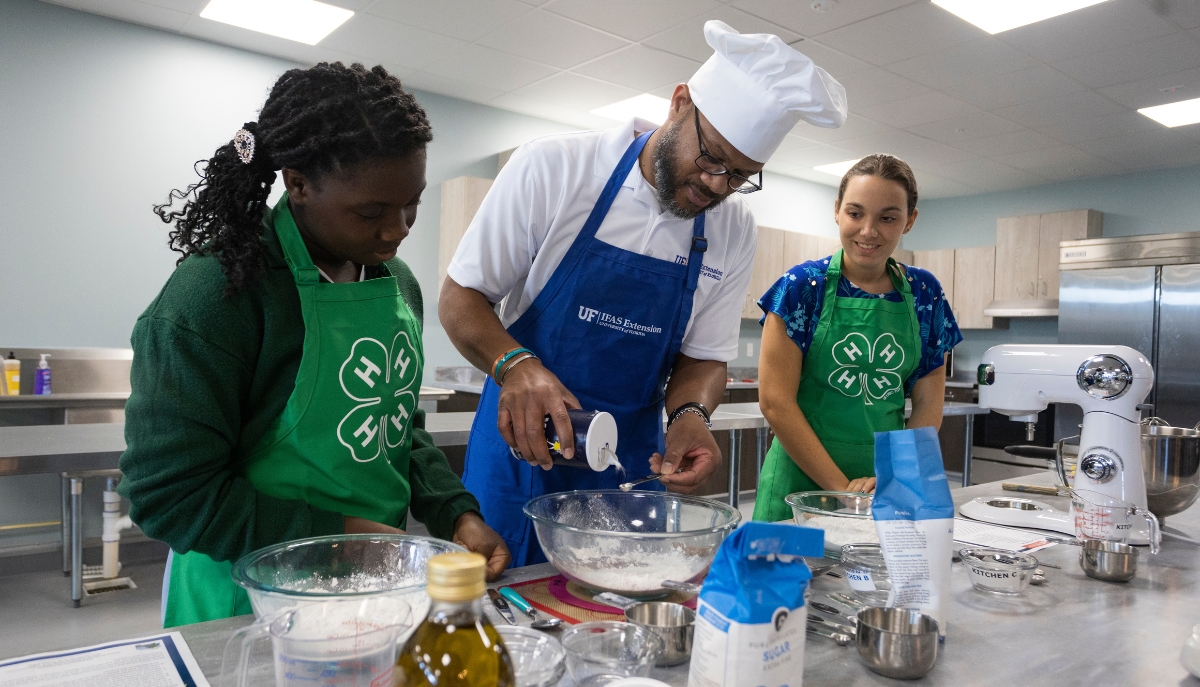 4-H teens and instructor baking
