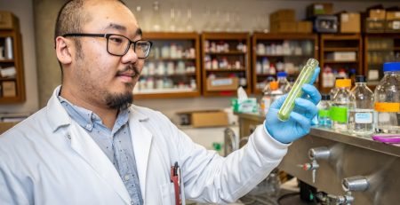 a scientist examines a test tube