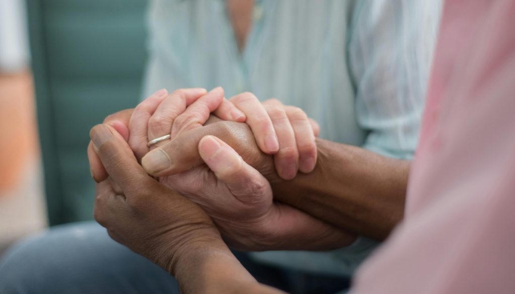 holding hands for support