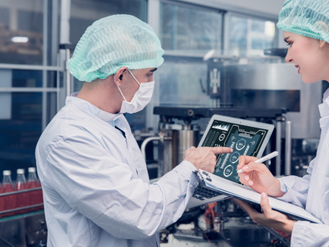 two scientists look at a tablet