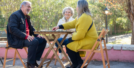 a group of seniors playing a game together in the park
