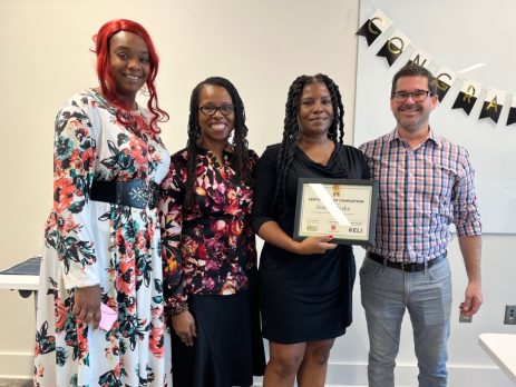 smiling program participant with a certificate