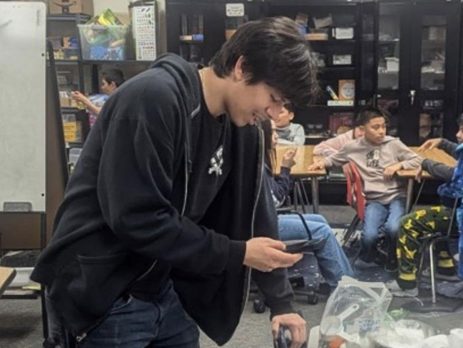 One of the participants in the Training for Teens program prepares a science experiment for his after-school class.