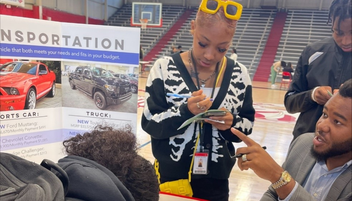 youth learn about financial education in a fair setting