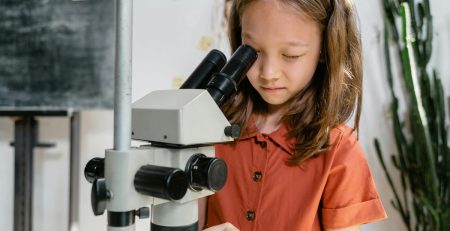 student looking into a microscope