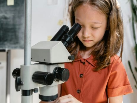 student looking into a microscope