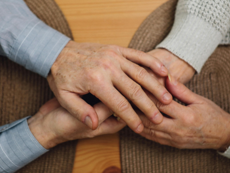 a closeup on two people holding hands