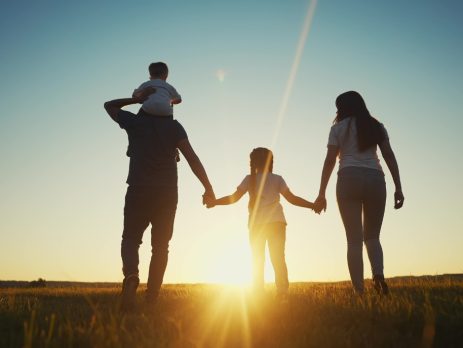 a family in silhouette, holding hands