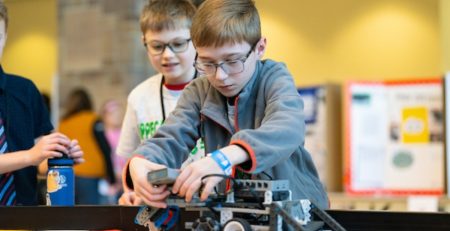 a 4-H student operates a robot