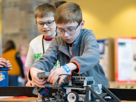 a 4-H student operates a robot