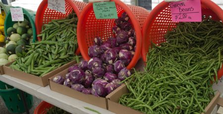 Vegetables for sale at a farmers market stand.